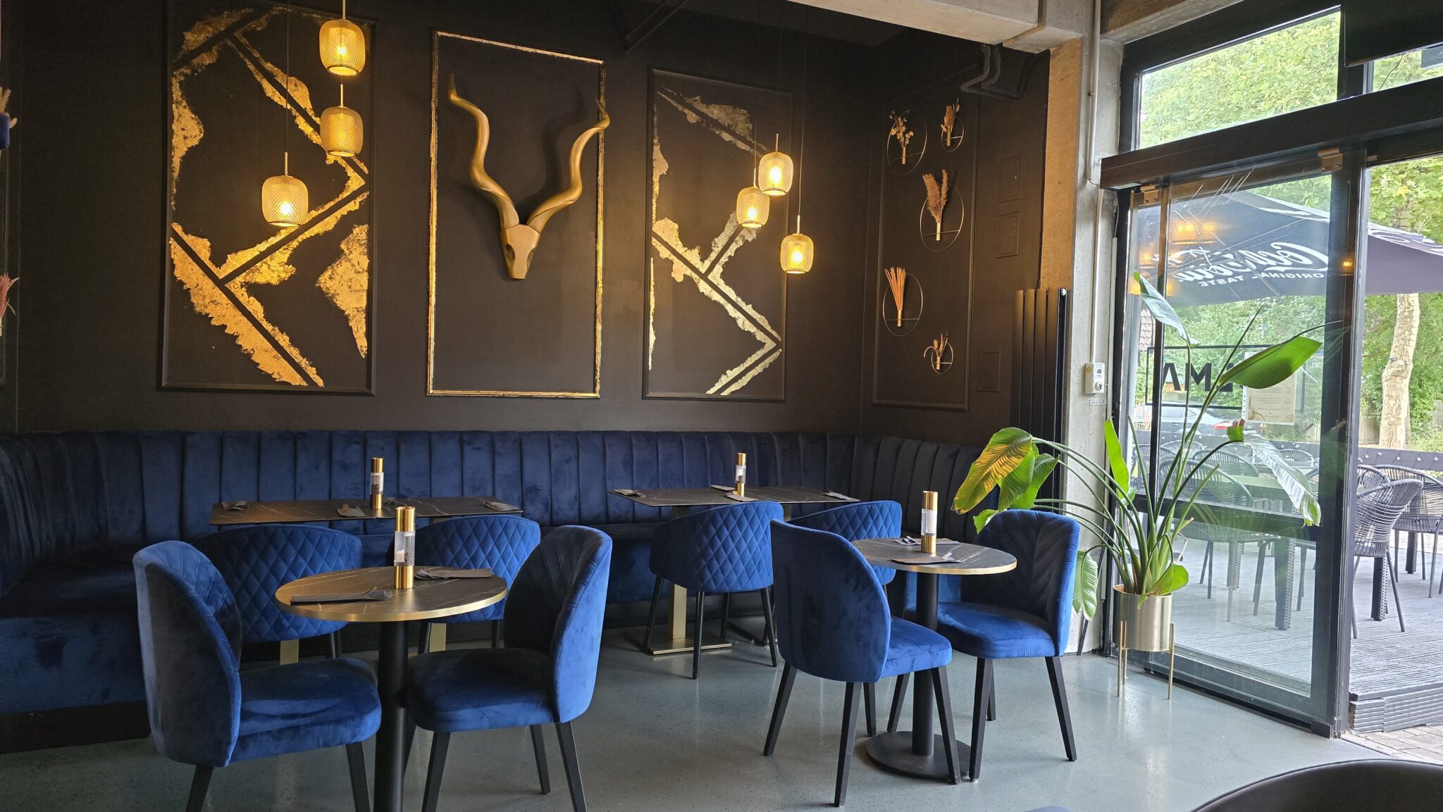 Modern eingerichteter Sitzbereich mit eleganter Wanddekoration in Ihrem Restaurant in der Nähe.